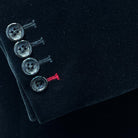 Functional sleeve buttonholes for practical styling on a black velvet tuxedo suit dinner jacket.