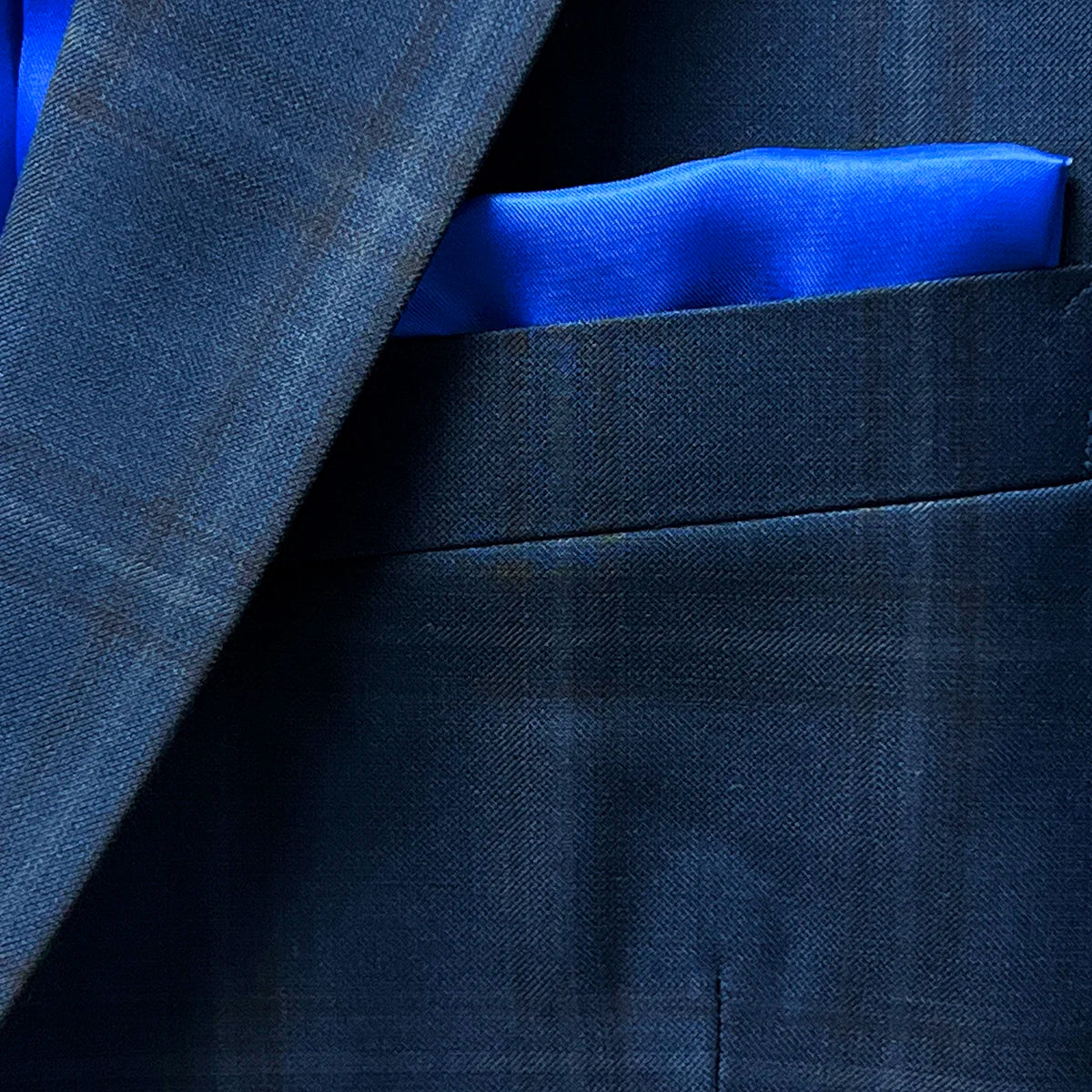 Close-up of the built-in pocket square on the dark midnight blue sportcoat.