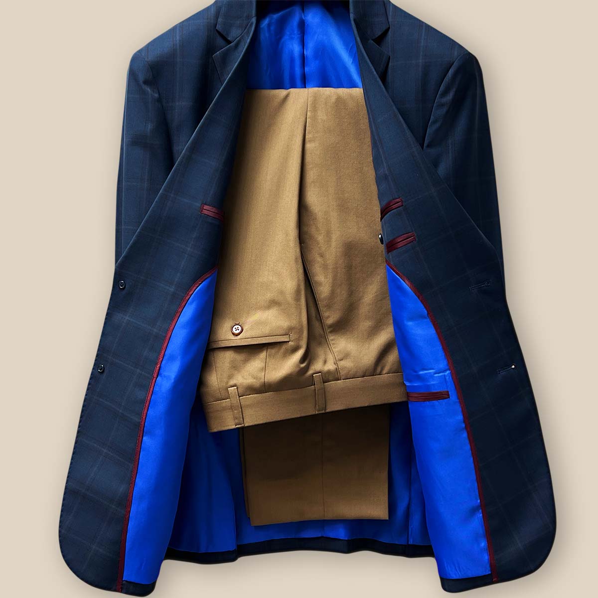 Front view of the two-piece set featuring the dark midnight blue sportcoat paired with tan trousers.