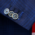 Close-up of the functional sleeve cuffs showing working buttonholes with the last button featuring royal blue contrast stitching as a bespoke detail