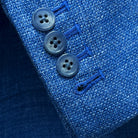 Functional sleeve buttonholes on the sportcoat, featuring matching pick stitching and blue horn buttons.