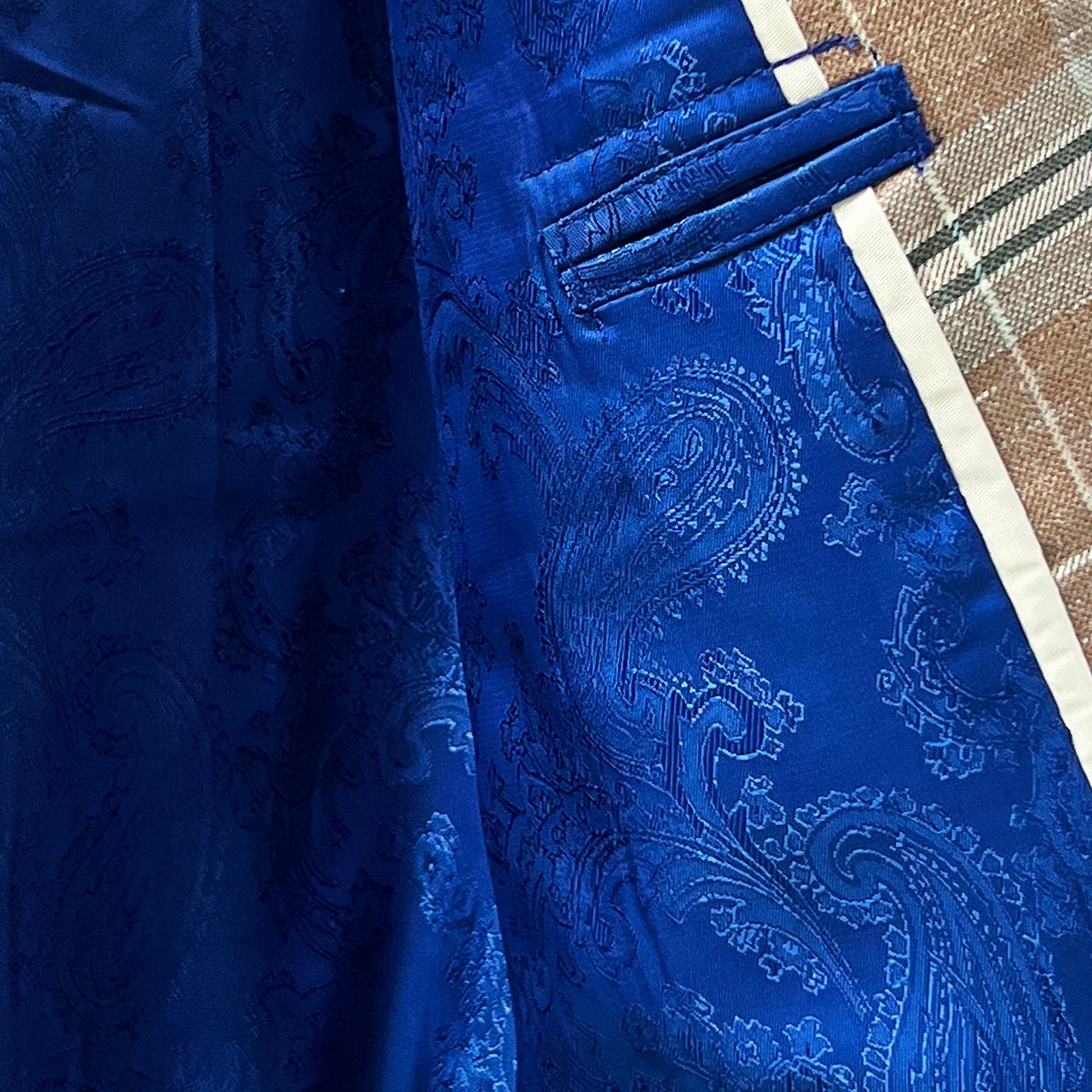 Flashy linings enhancing the interior of a brown beige men's sport coat with blanched almond and midnight blue windowpane pattern.