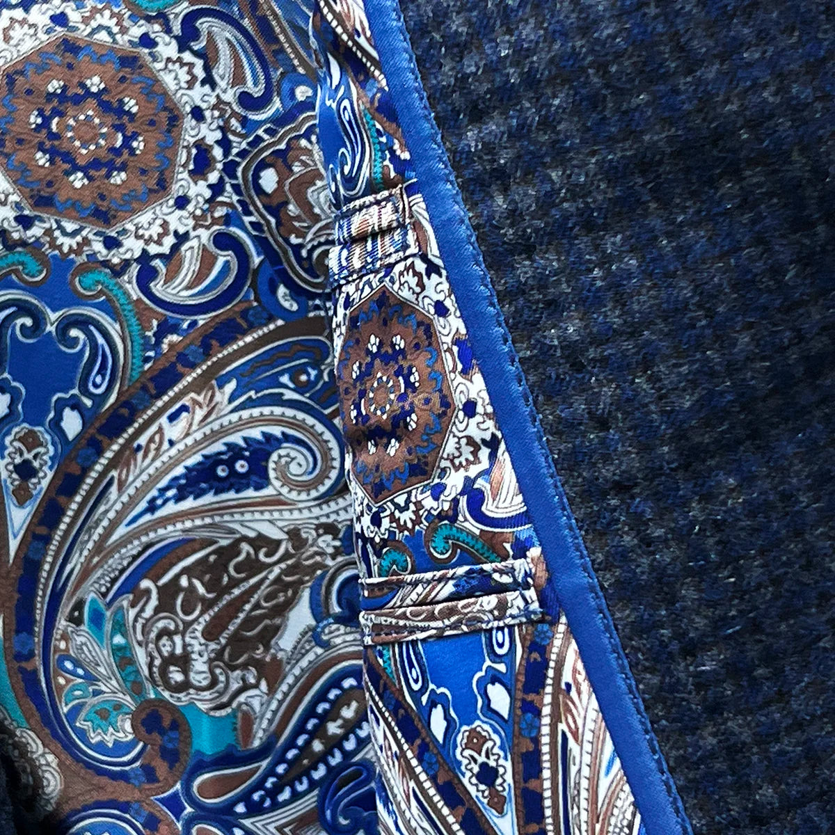 Flash linings adding a vibrant touch to a gray blue mini grid checks sport coat made of flannel wool.