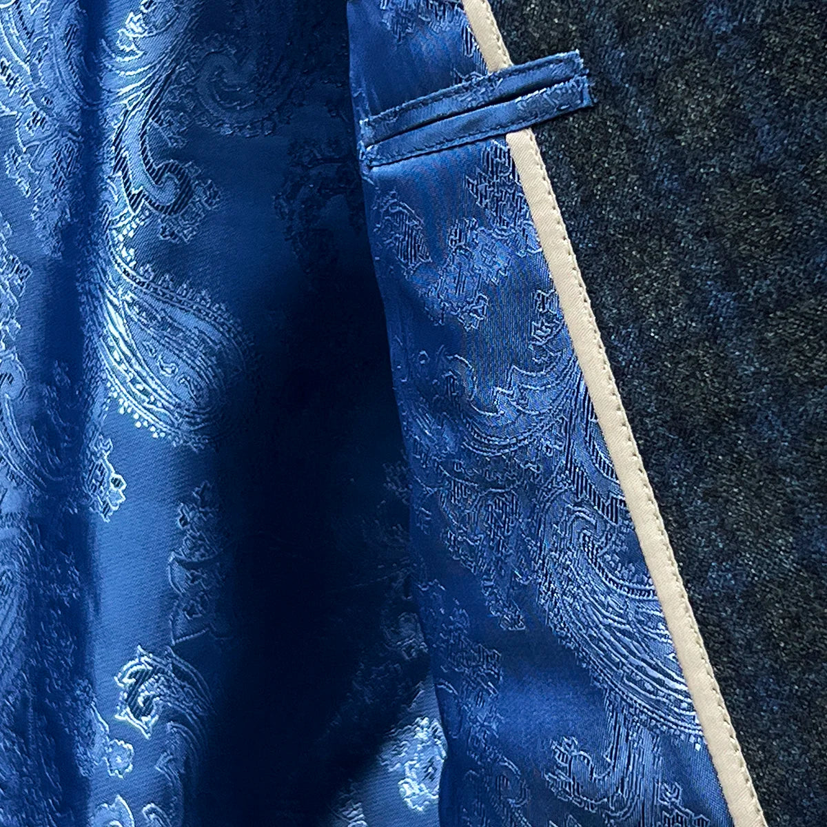 Vibrant flash linings inside a grey blue grid check flannel sportcoat.