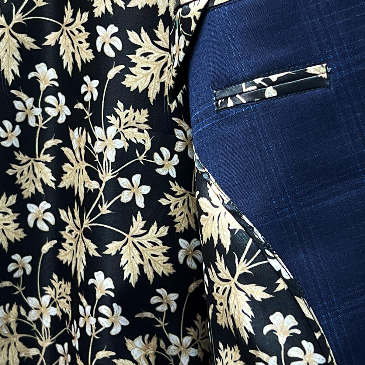 Vibrant flash linings adding a hidden surprise to a midnight blue windowpane suit.
