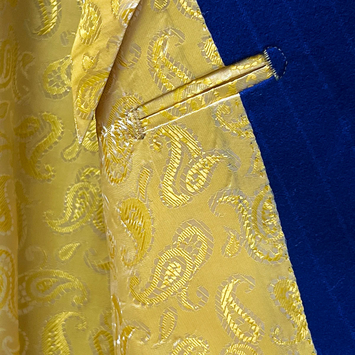 Flashy yellow gold lining inside the royal blue pinstripe suit.