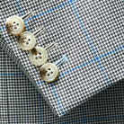 Functional sleeve buttonholes on men's coats made with Biella, Italy fabric.