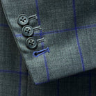 Functional sleeve buttonholes on a grey purple windowpane sportcoat.