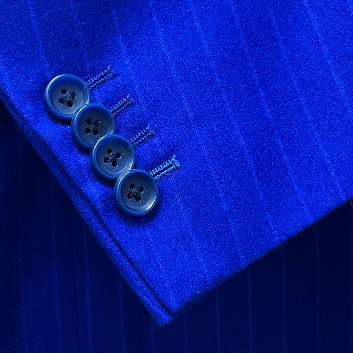 Functional sleeve buttonholes in the royal blue pinstripe suit.
