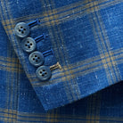 Functional sleeve buttonholes on a sky blue with tan windowpane men's sport coat allowing for precise fit adjustments.