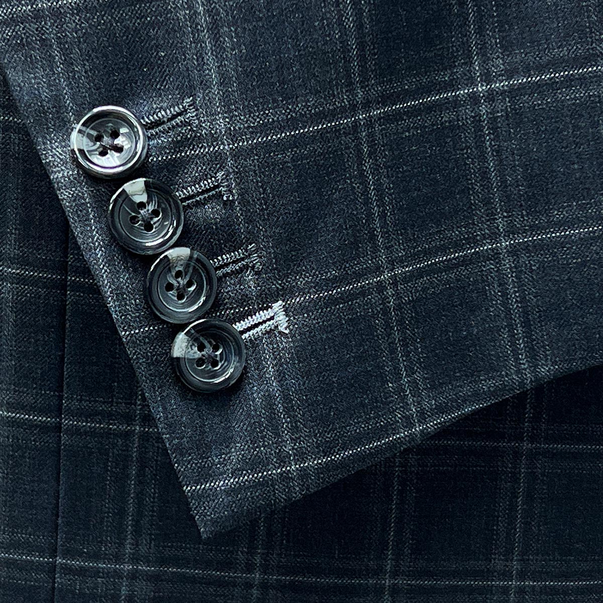 Functional sleeve buttonholes feature on Westwood Hart Grey Plaid Windowpane Men's 3pc Suit, Silk Bemberg Sky Blue Lining