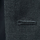 Macro detail of buttonhole stitching showing precise tailoring on dark grey birdseye fabric