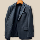 Interior right panel view of dark grey suit jacket showing bemberg silk lining construction and pocket details