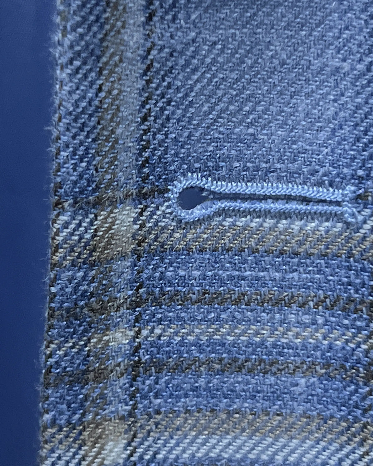 Buttonhole detail of Powder Blue with Tan Windowpane Plaid men's sport coat showing the front buttonhole finish