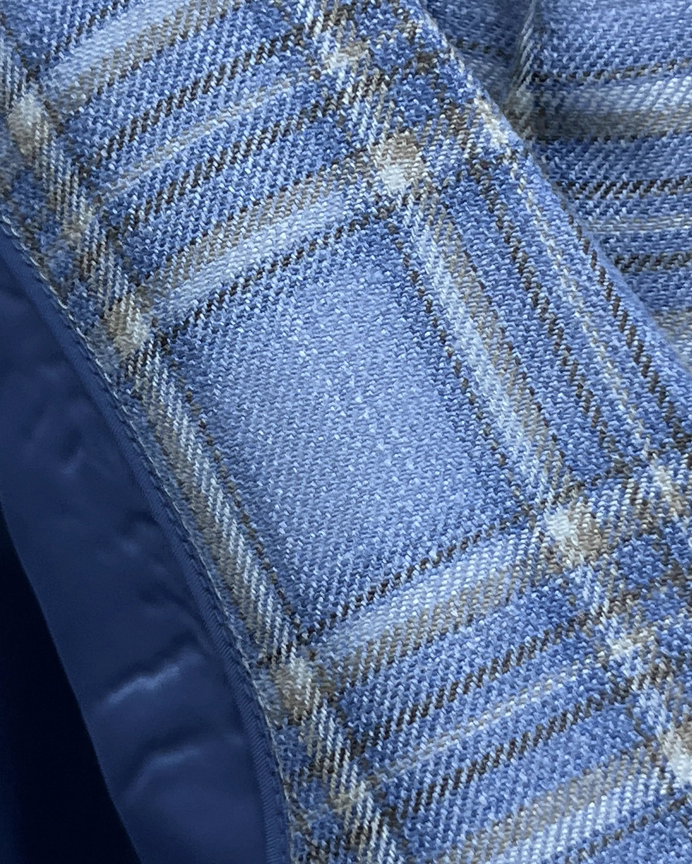 Fabric close up of Powder Blue with Tan Windowpane Plaid men's sport coat showing the cloth texture and weave