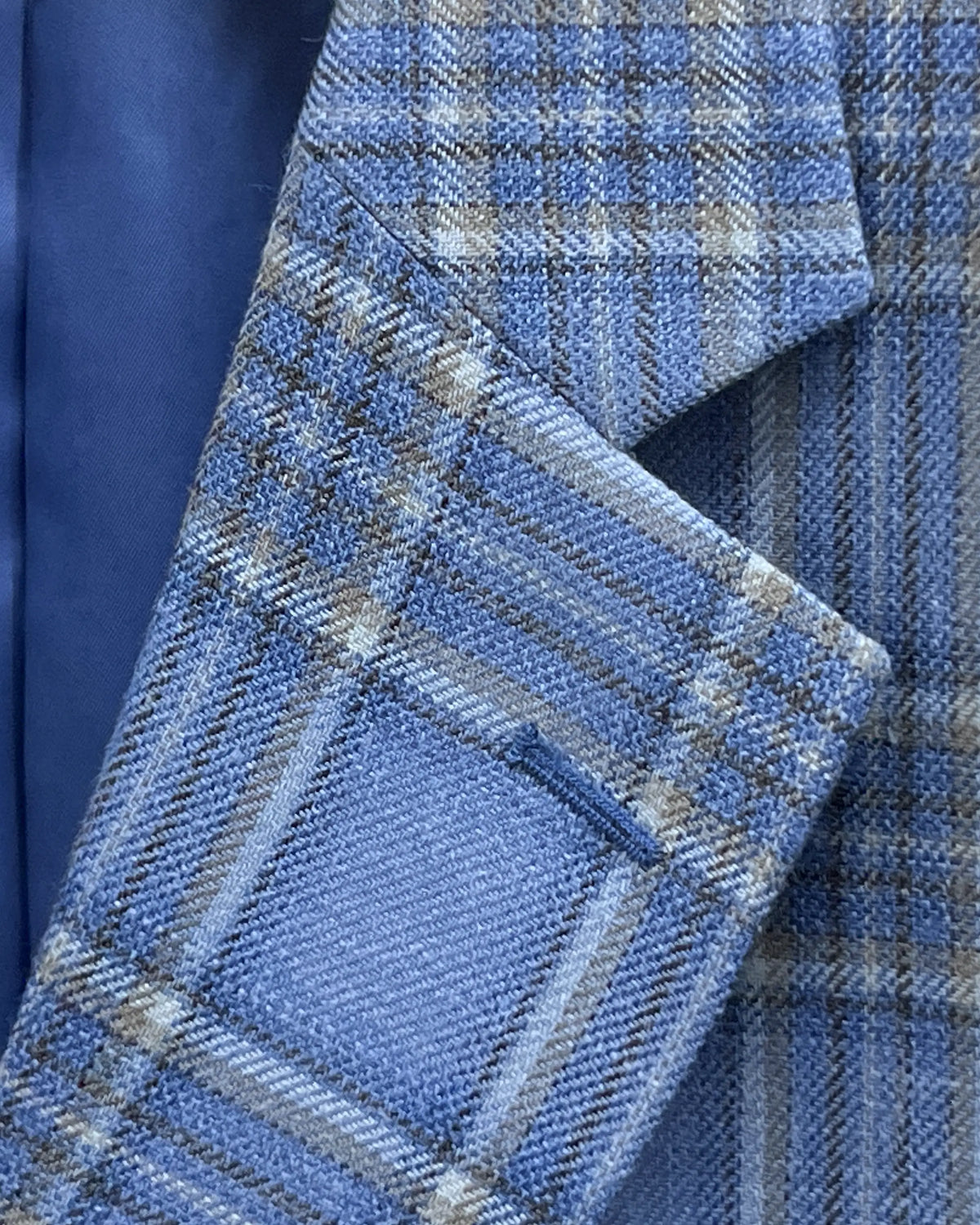 Lapel detail of Powder Blue with Tan Windowpane Plaid men's sport coat showing the lapel buttonhole with sky blue thread