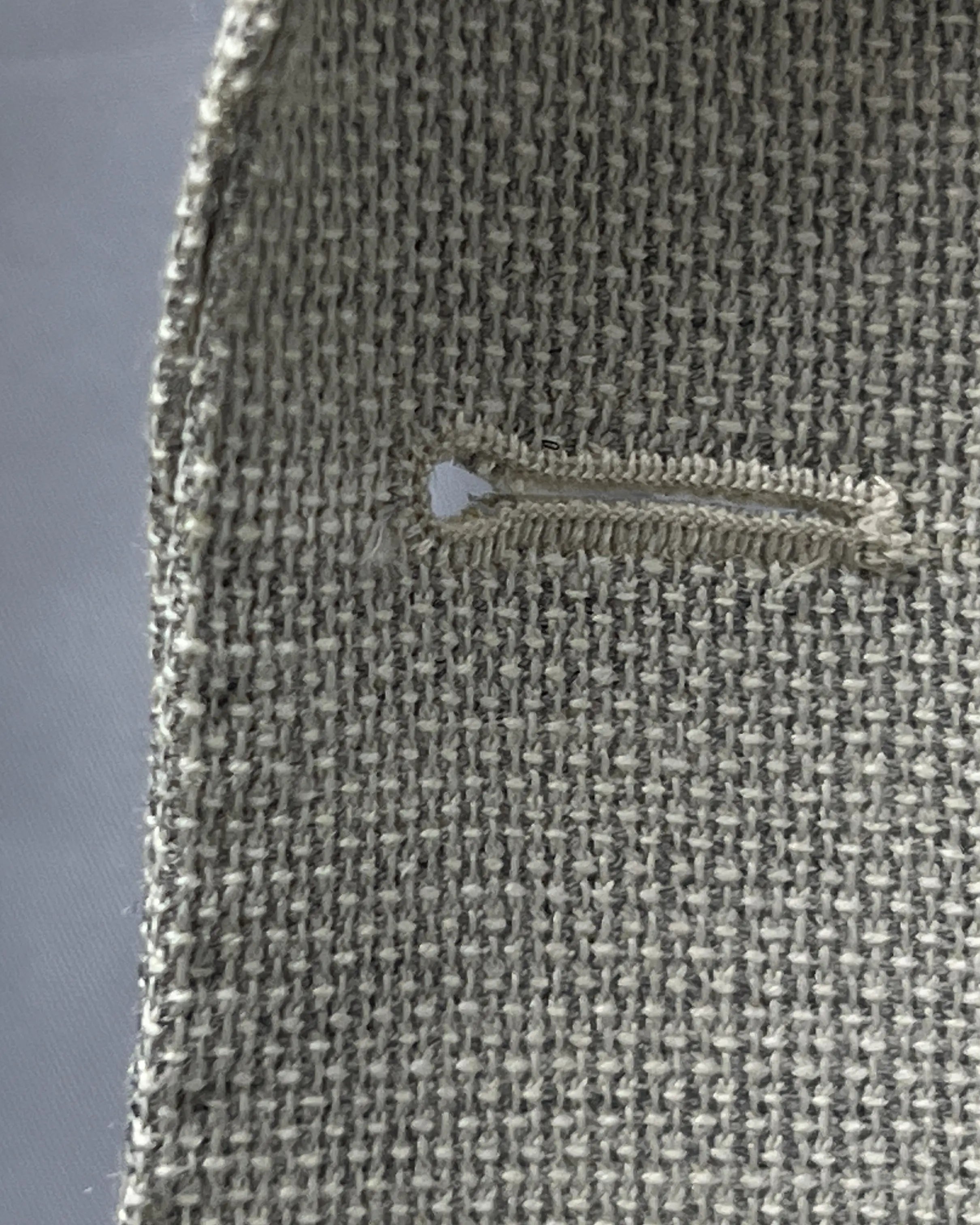 Buttonhole detail of light tan hopsack men's sport coat showing the front buttonhole finish