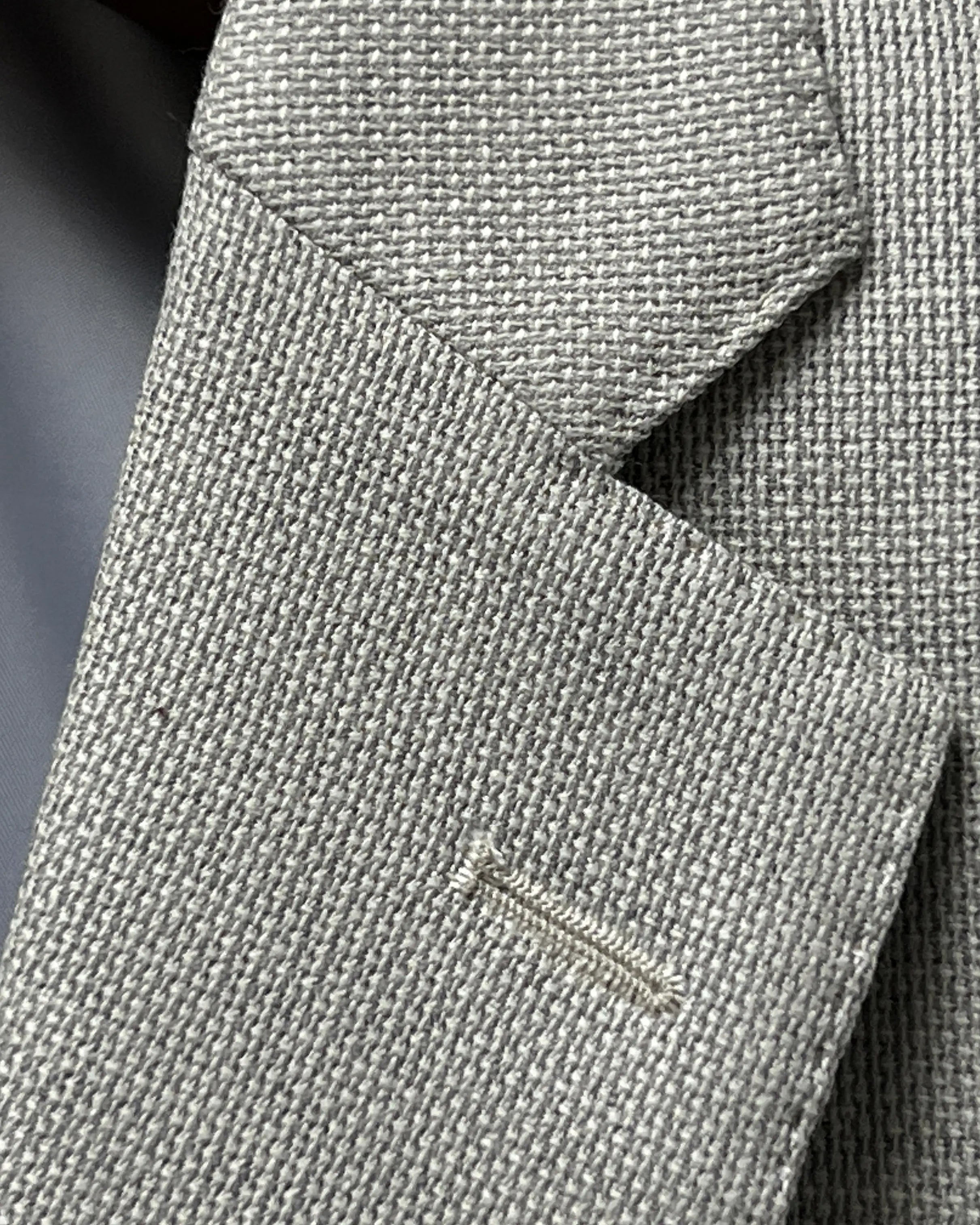 Lapel buttonhole detail of light tan hopsack men's sport coat showing the standard lapel buttonhole stitching