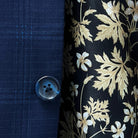 Classic horn buttons enhancing the elegance of a midnight blue windowpane suit.