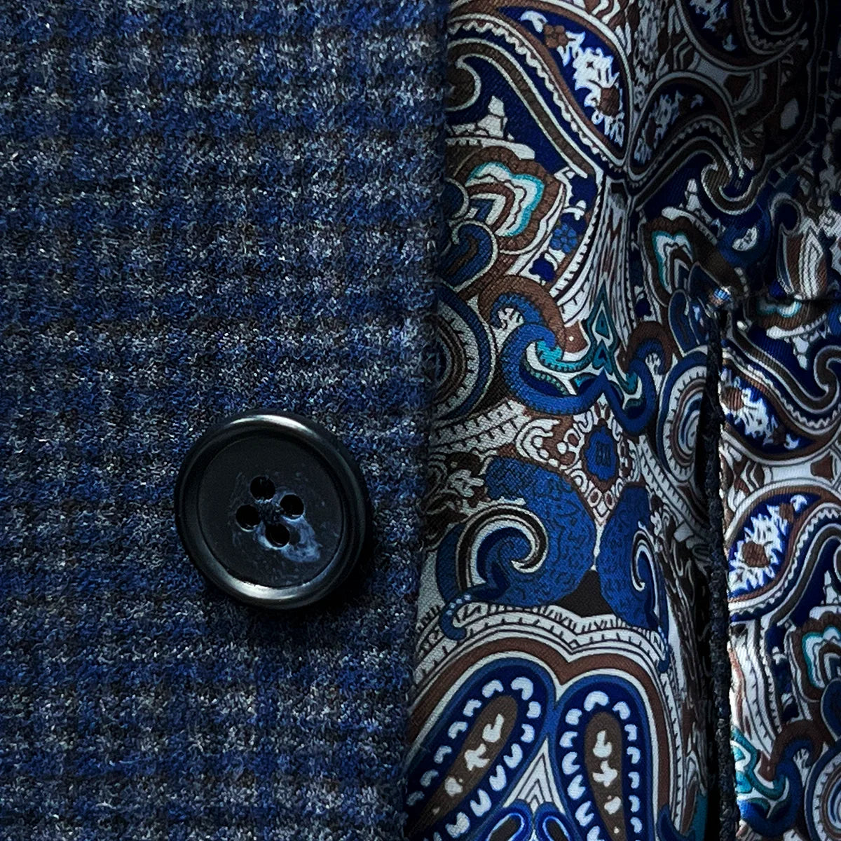 Horn marble buttons adding a classic touch to a gray blue mini grid checks sport coat made of flannel wool.