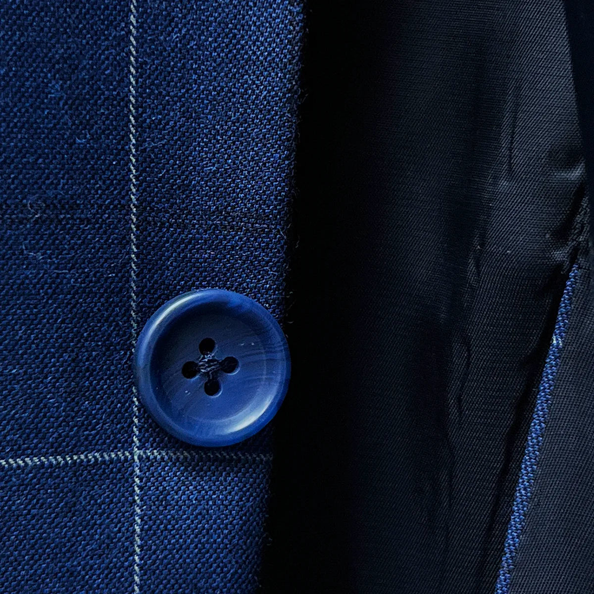 Blue horn marble buttons on a navy blue windowpane suit