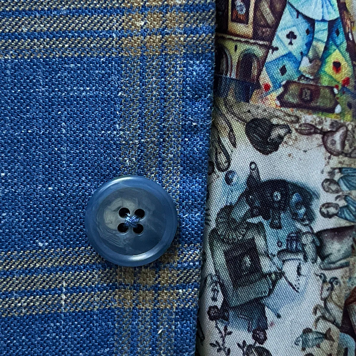 Horn marble buttons enhancing the classic look of a sky blue with tan windowpane men's sport coat.