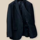Inside view of the left side of a classic black men's suit showcasing inner craftsmanship.