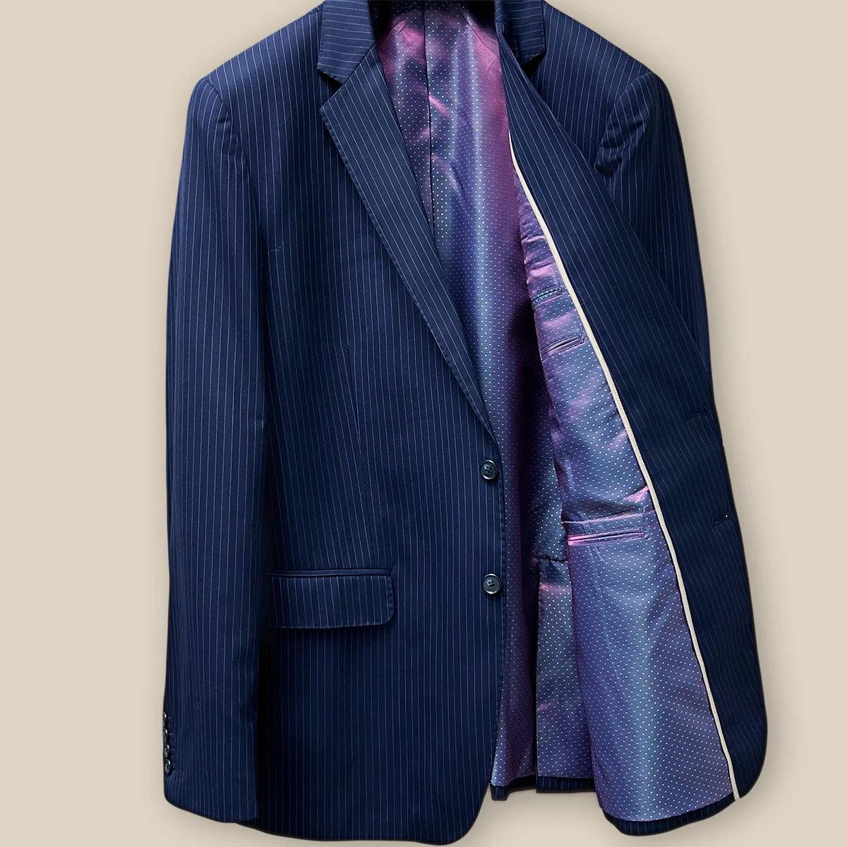 Inside left view of a navy suit with purple pinstripes, showing the internal details and craftsmanship.