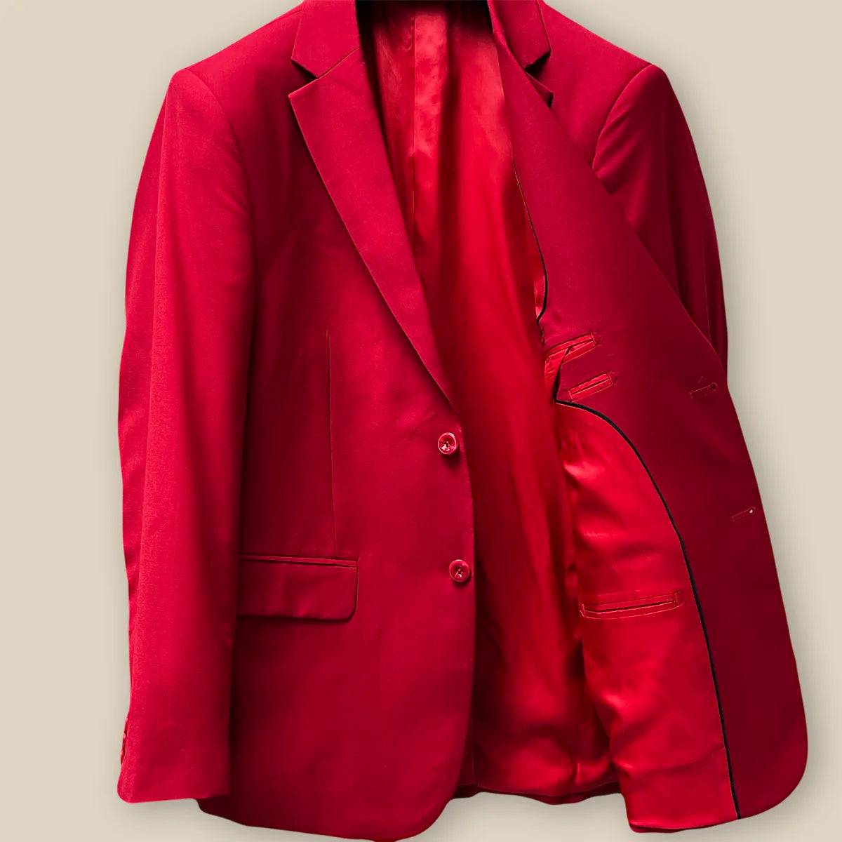 Inside jacket left view displaying the inner lining and pockets on a scarlet red, solid plain color suit.