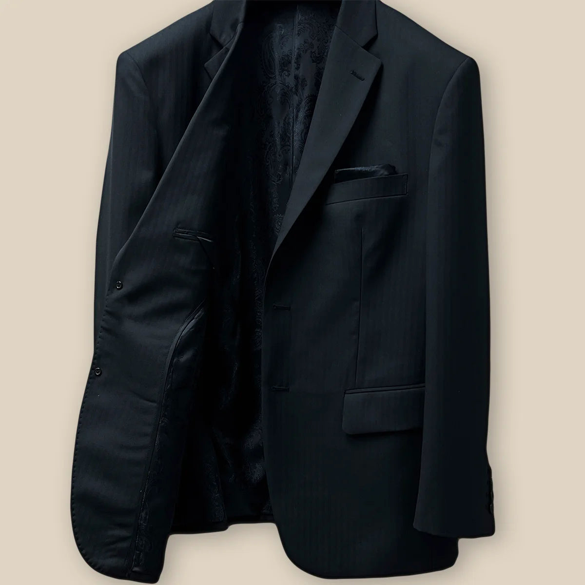 Right inside view of a black herringbone men's suit.