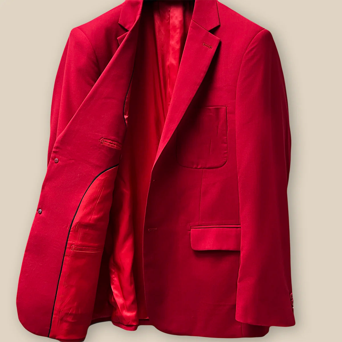Inside jacket right view revealing the interior craftsmanship on a scarlet red, solid plain color suit.