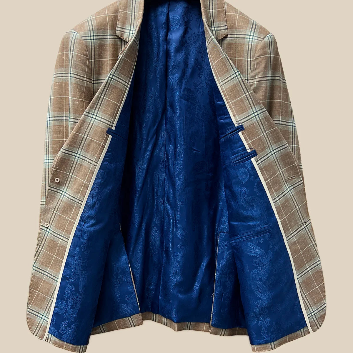 Inside view displaying the craftsmanship of a brown beige men's sport coat with blanched almond and midnight blue windowpane pattern.