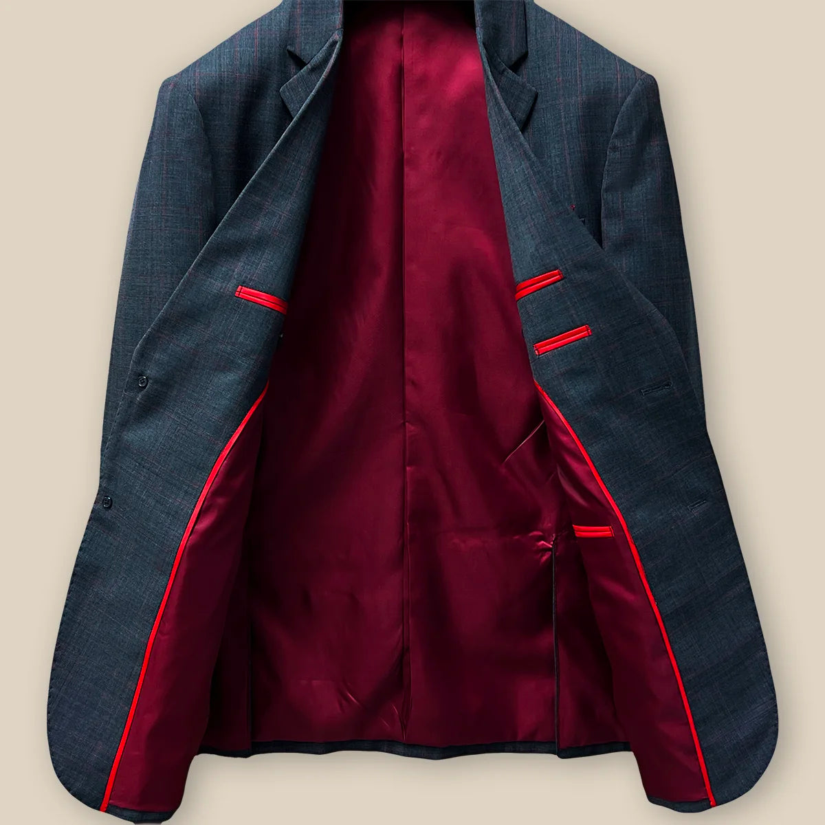 Inside jacket view revealing the overall interior craftsmanship on a charcoal grey prince of wales plaid with maroon windowpane suit.