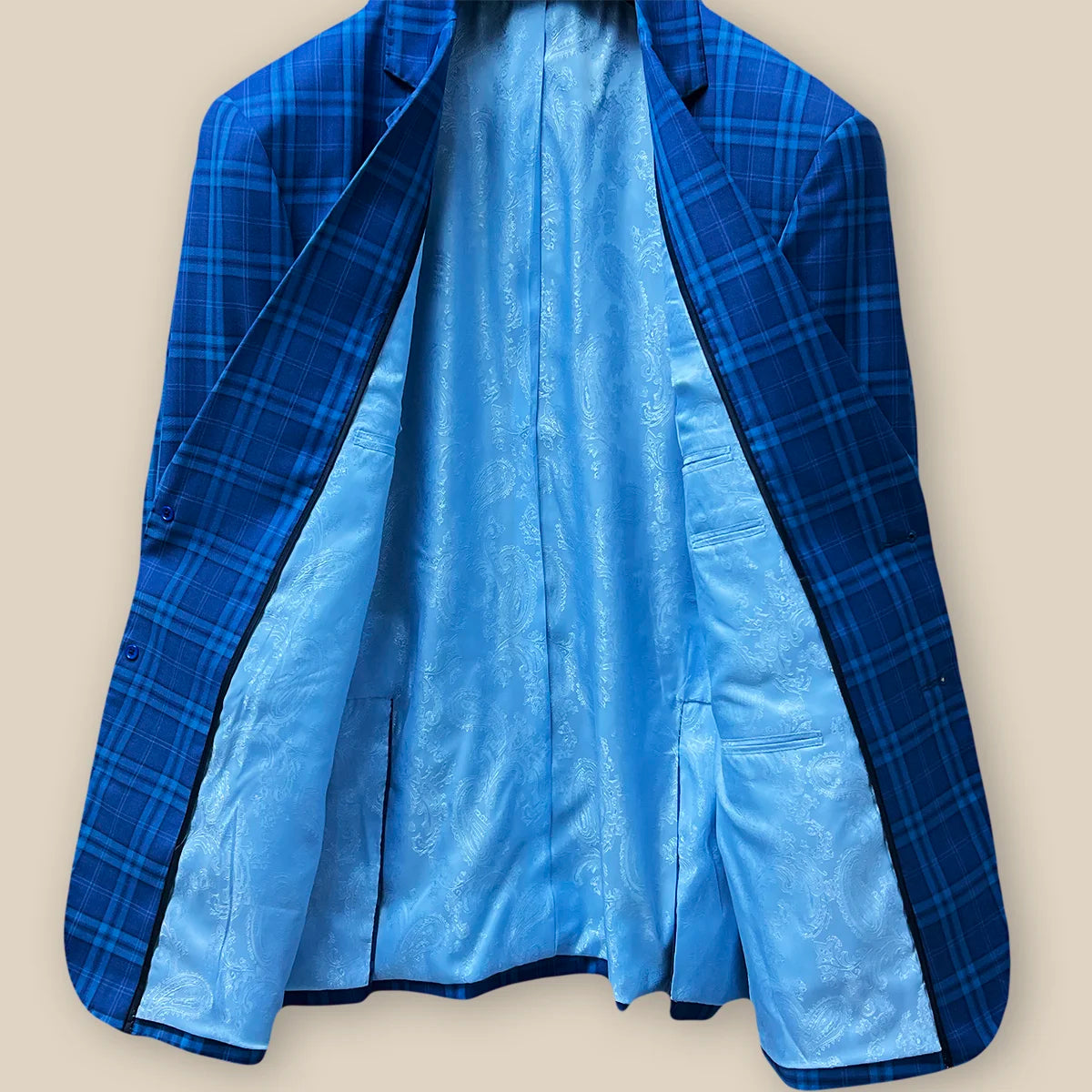 Inside view displaying the overall inner construction of a colbalt blue checkered plaid men's sport coat.