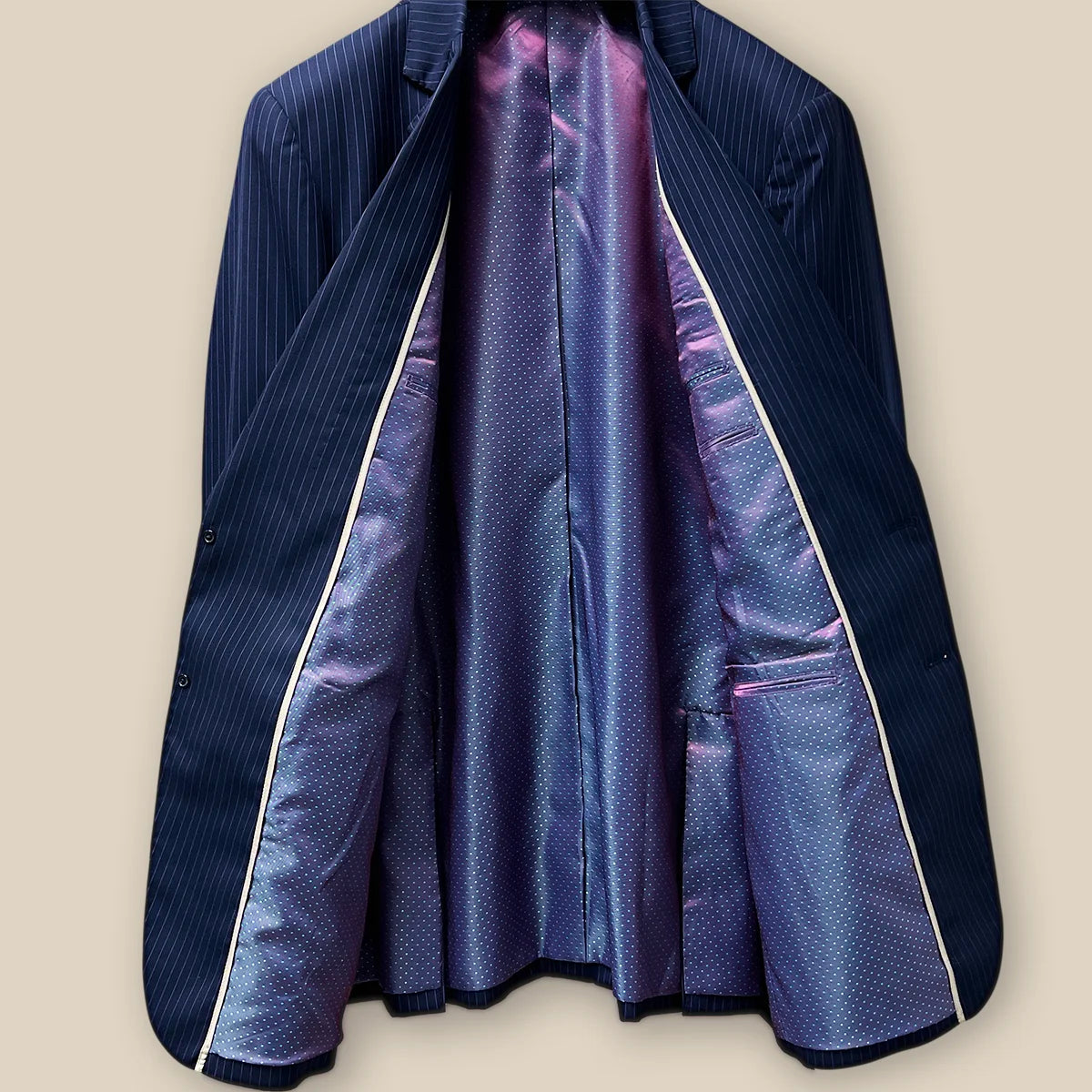 Inside view of a navy suit with purple pinstripes, displaying the quality of materials and construction.