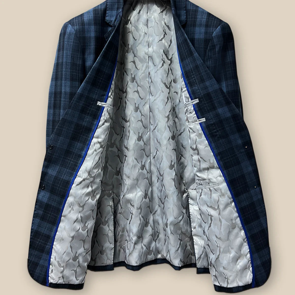 Interior view of a Prussian Blue sportcoat with black grid checks.