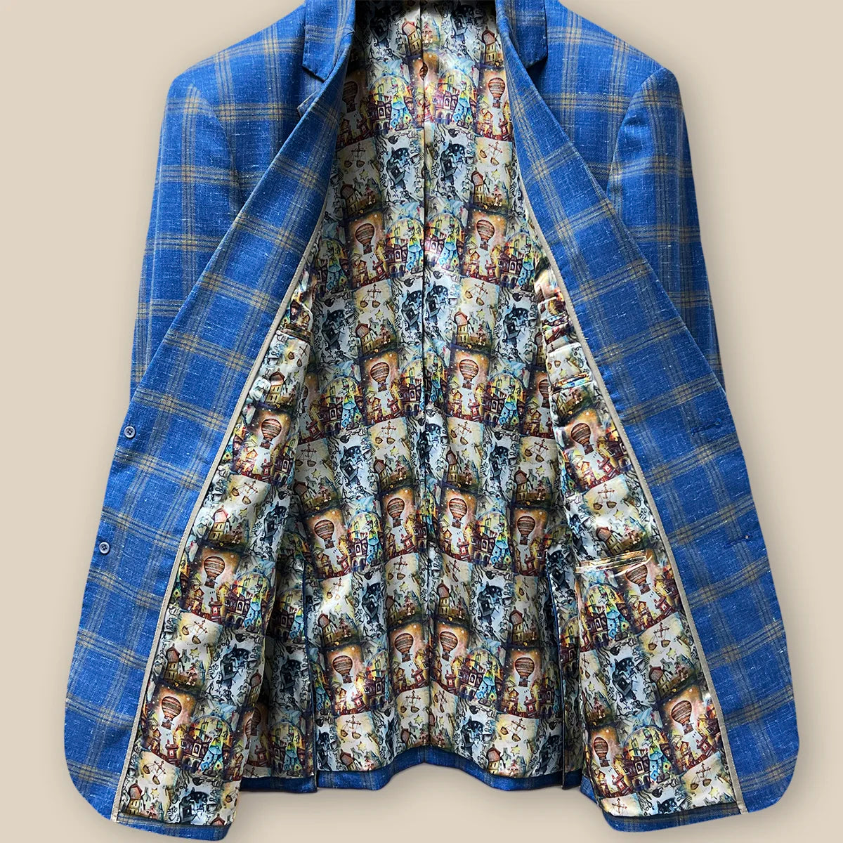 Inside view displaying the lining and inner pockets of a sky blue with tan windowpane men's sport coat.