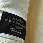 View of the flash linings inside the ivory tuxedo jacket, featuring off white paisley design for a stylish interior.