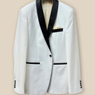 Detailed view of the ivory tuxedo jacket button panel with black satin covered buttons and refined stitching.
