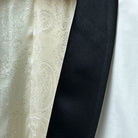 Elegant shawl lapel on the ivory tuxedo jacket, featuring a luxurious black silk satin trim.
