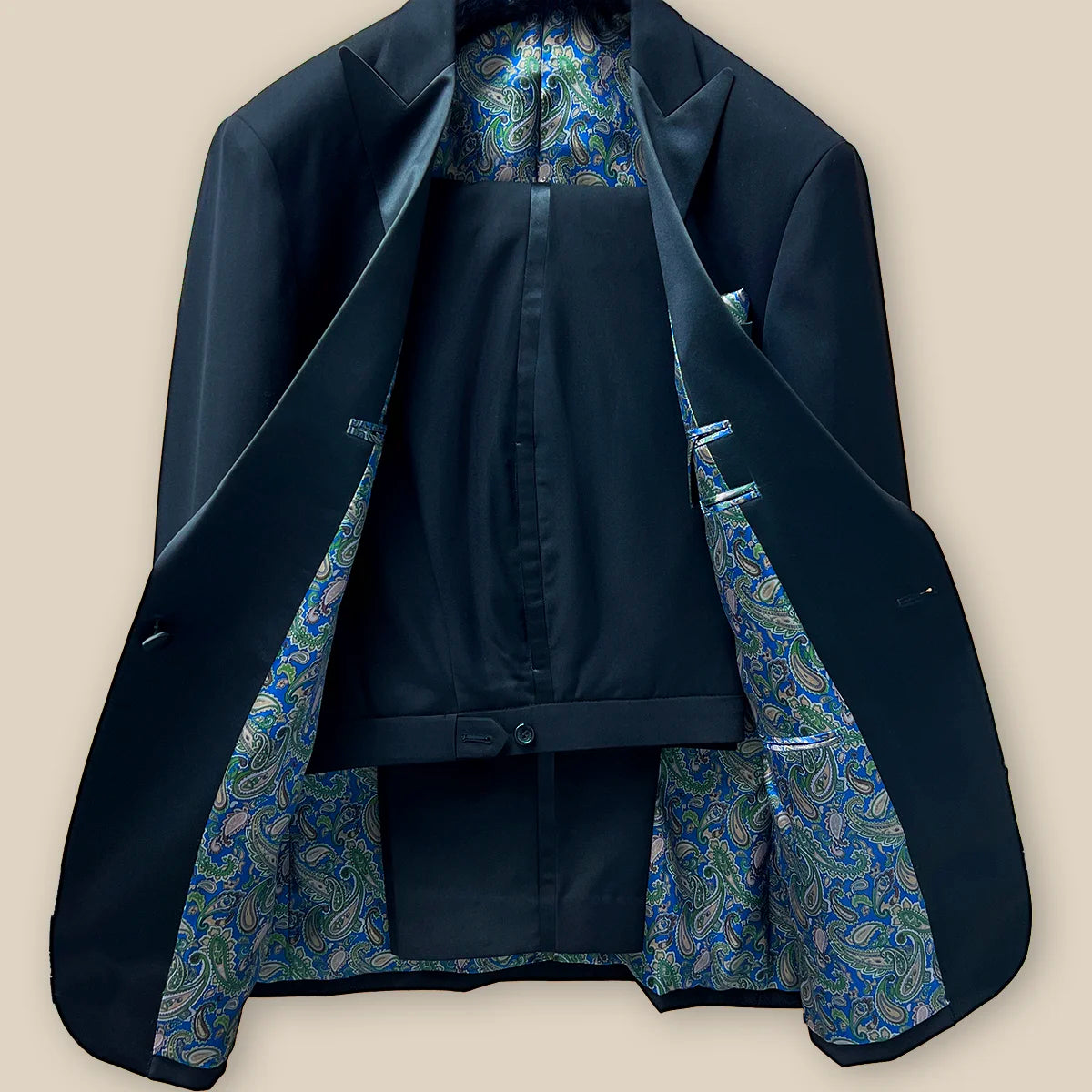 Full view of a coordinated black tuxedo suit dinner jacket and pants showcasing a formal look.