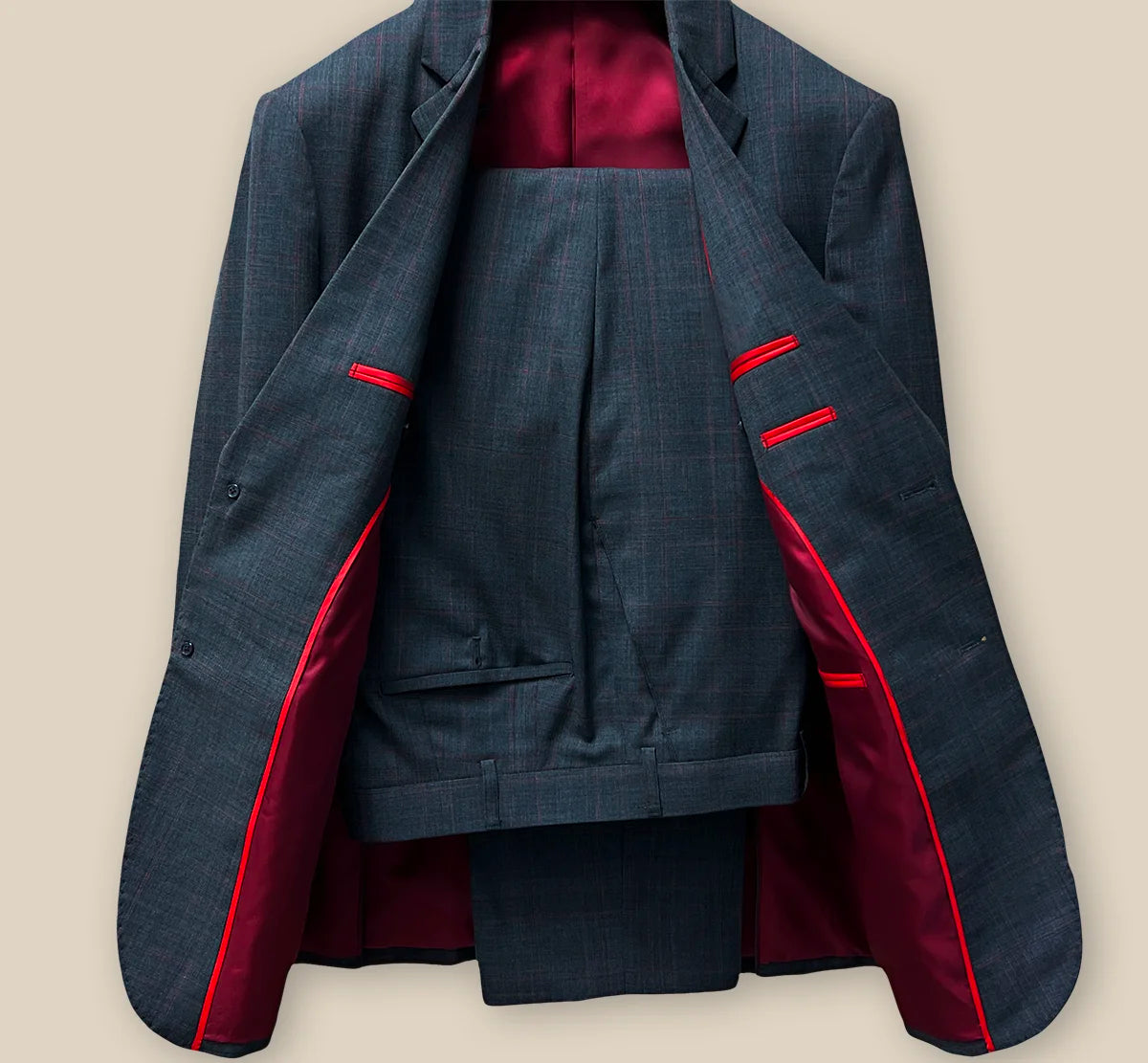 Jacket and pants full suit view offering a comprehensive look at the charcoal grey prince of wales plaid with maroon windowpane ensemble.