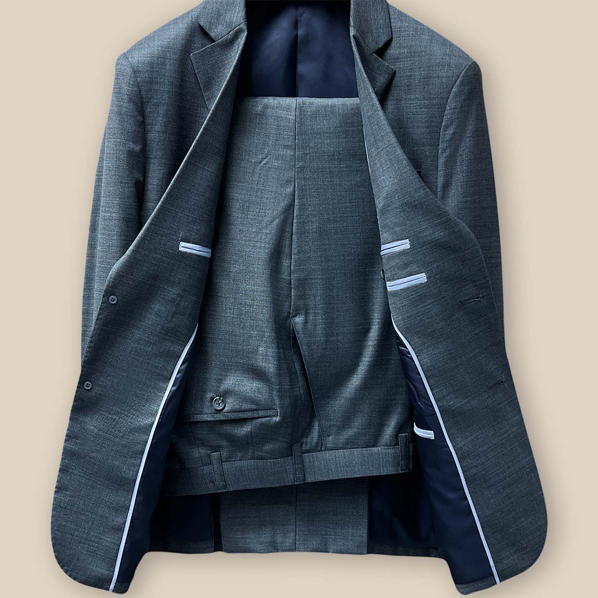 Full view of a dark grey nailhead suit, showcasing the jacket and pants together.