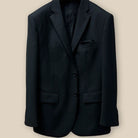 Front button panel of a black herringbone men's suit.