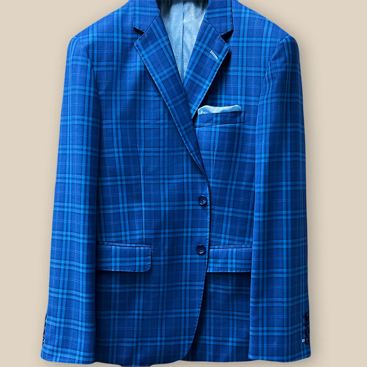 Button panel view presenting the fastening system of a colbalt blue checkered plaid men's sport coat.