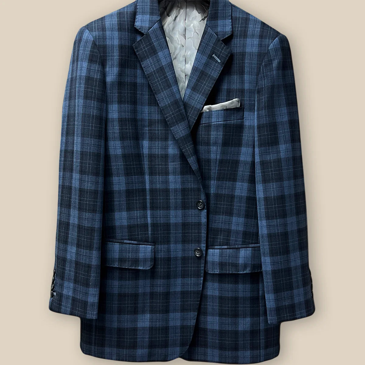 View of the jacket buttonhole panel on a Prussian Blue sportcoat with black grid checks.