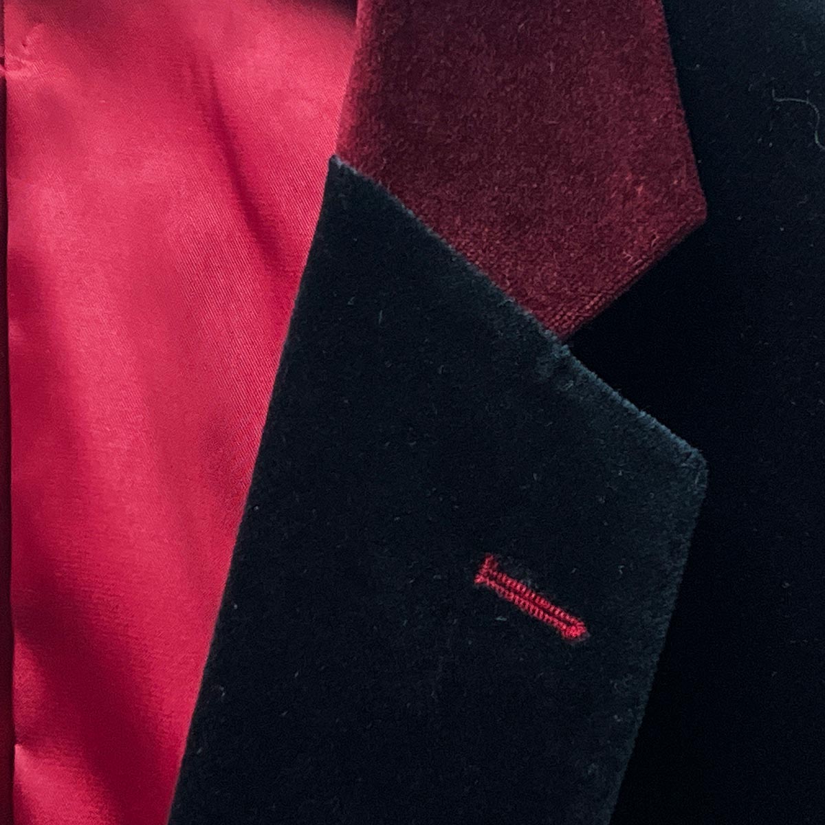 Neat lapel buttonhole on a black velvet tuxedo suit dinner jacket.