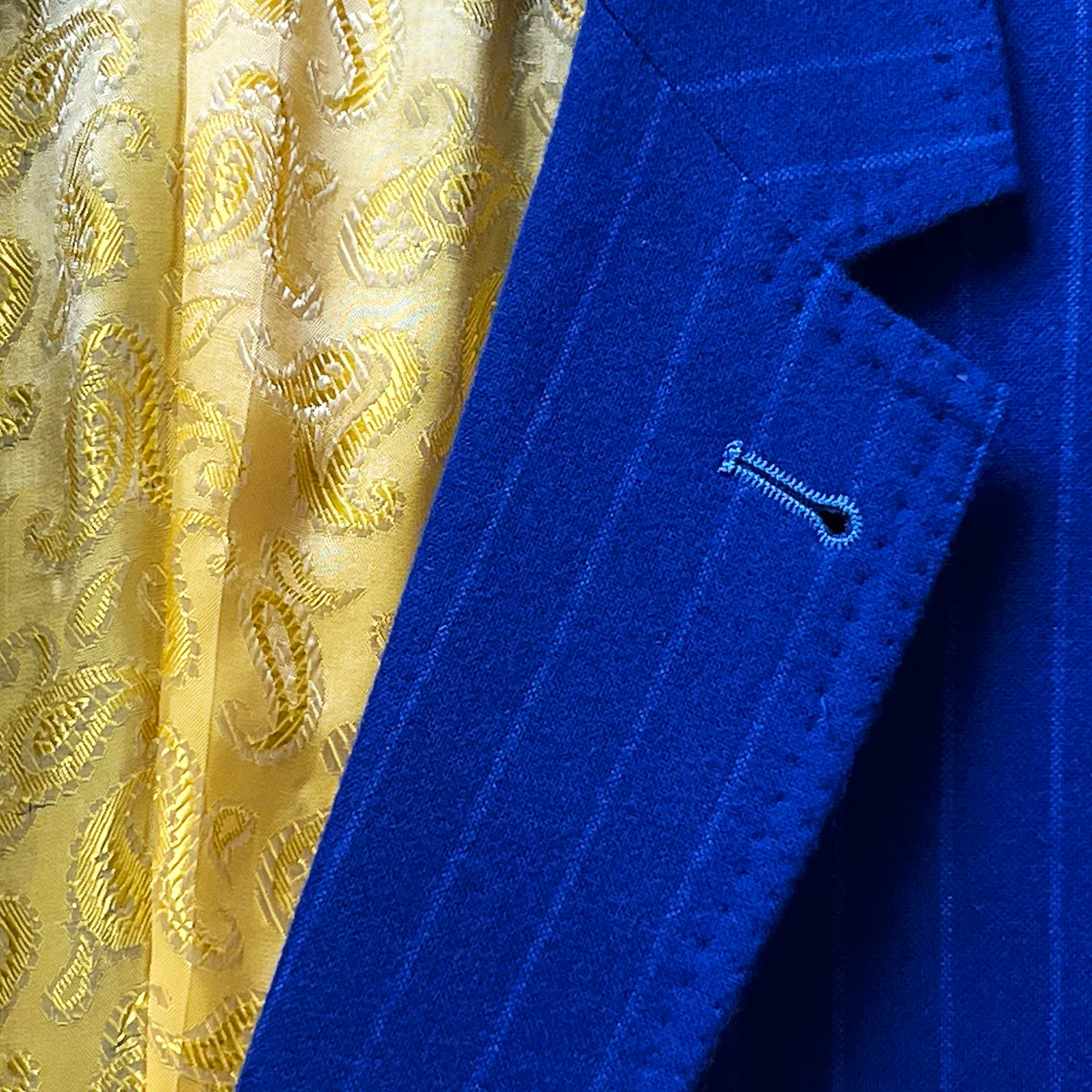 Distinctive lapel buttonhole on a royal blue pinstripe suit.