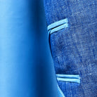 Close-up of sky blue bemberg silk lining texture and sheen in light blue solid Irish linen men's suit jacket