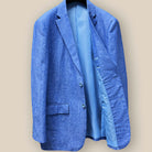 Interior view of light blue solid Irish linen men's suit jacket, showcasing sky blue bemberg silk lining on the right side